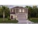 Two-story house with brown siding, attached garage, and landscaping at 673 Bell Prairie Cir, Lake Wales, FL 33859