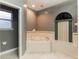 Bathroom with corner bathtub and a window with blinds at 353 Ruby Lake Loop, Winter Haven, FL 33884