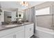 Bathroom with double vanity and a bathtub at 8989 Cabot Cliffs Dr, Davenport, FL 33896
