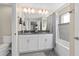Bathroom with double vanity, soaking tub, and gray tile at 8989 Cabot Cliffs Dr, Davenport, FL 33896