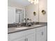 Double vanity bathroom with granite countertops and updated fixtures at 8989 Cabot Cliffs Dr, Davenport, FL 33896
