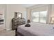 Bedroom with a dresser, large bed, and window with blinds at 8989 Cabot Cliffs Dr, Davenport, FL 33896