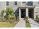 Townhome entrance with walkway, landscaping, and parking area at 8989 Cabot Cliffs Dr, Davenport, FL 33896