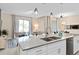 Kitchen island with double sink, granite countertop, and breakfast bar at 8989 Cabot Cliffs Dr, Davenport, FL 33896
