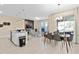 Open kitchen with island, stainless steel appliances, and dining area at 8989 Cabot Cliffs Dr, Davenport, FL 33896
