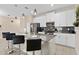 Modern kitchen with white cabinets, granite counters, and stainless steel appliances at 8989 Cabot Cliffs Dr, Davenport, FL 33896