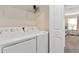 Laundry room with washer, dryer, and shelving at 8989 Cabot Cliffs Dr, Davenport, FL 33896