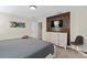 Main bedroom with king bed and wood accent wall at 8989 Cabot Cliffs Dr, Davenport, FL 33896
