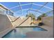 Screened-in pool with lounge chair and inflatable ball at 8989 Cabot Cliffs Dr, Davenport, FL 33896
