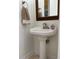 Charming pedestal sink with decorative mirror in a half-bath at 899 W Lake Marion Rd, Haines City, FL 33844