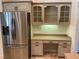 Kitchen with built-in desk, stainless steel appliances, and ample cabinetry at 899 W Lake Marion Rd, Haines City, FL 33844