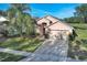 Two-story house next to a lake, with a backyard at 16741 Rising Star Dr, Clermont, FL 34714