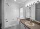 Updated bathroom with a tub, sink, and large mirror at 16741 Rising Star Dr, Clermont, FL 34714
