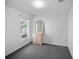 Bedroom with grey carpet, dresser, and large window at 16741 Rising Star Dr, Clermont, FL 34714