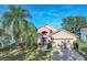 Two-story house with a two-car garage and palm trees at 16741 Rising Star Dr, Clermont, FL 34714
