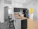 Kitchen features dark cabinets, stainless steel appliances, and a breakfast bar at 16741 Rising Star Dr, Clermont, FL 34714