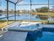 Relaxing screened-in spa and pool with lake view at 16741 Rising Star Dr, Clermont, FL 34714