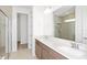 Bright bathroom featuring double sinks, granite countertops, and a glass-enclosed shower, perfect for a modern home at 4471 Sw 84Th Street Rd, Ocala, FL 34476