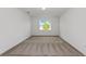 Comfortable bedroom featuring neutral walls, plush carpet, and a bright window with backyard views at 4471 Sw 84Th Street Rd, Ocala, FL 34476