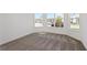 Empty bedroom with wall-to-wall carpet and large windows at 4471 Sw 84Th Street Rd, Ocala, FL 34476