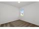 Cozy bedroom with neutral carpet flooring and a window offering views of the neighborhood at 4471 Sw 84Th Street Rd, Ocala, FL 34476