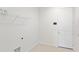 Functional laundry room with tile floors, ample storage shelves, and a clean, organized layout at 4471 Sw 84Th Street Rd, Ocala, FL 34476