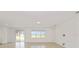Open living room bathed in natural light showcasing neutral walls and tile floors at 4471 Sw 84Th Street Rd, Ocala, FL 34476