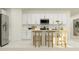 Modern kitchen with white cabinets, island, and stainless steel appliances at 1982 Sarah St, Winter Haven, FL 33884