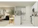 Modern kitchen with white cabinets, island, and stainless steel appliances at 1982 Sarah St, Winter Haven, FL 33884