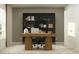 Modern home office with a large desk, shelving, and natural light at 1982 Sarah St, Winter Haven, FL 33884