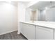 Modern bathroom with white cabinets and a large mirror at 3179 Seville St, Lake Alfred, FL 33850