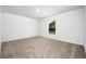 Simple bedroom with neutral carpeting and a window at 3179 Seville St, Lake Alfred, FL 33850