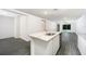 Open concept kitchen with white cabinets, granite island, and stainless steel appliances at 3179 Seville St, Lake Alfred, FL 33850