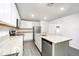 Modern kitchen with white cabinets, granite island, and stainless steel appliances at 3179 Seville St, Lake Alfred, FL 33850