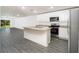 Modern kitchen with white cabinets, granite island, and stainless steel appliances at 3179 Seville St, Lake Alfred, FL 33850