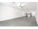 Bright living room with gray vinyl plank flooring and ceiling fan at 3179 Seville St, Lake Alfred, FL 33850