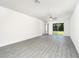 Spacious living room with gray vinyl plank flooring and sliding glass doors at 3179 Seville St, Lake Alfred, FL 33850