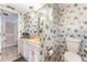Bathroom featuring butterfly themed wallpaper, modern toilet and lighting at 6141 Palmetto Dr, Indian Lake Estates, FL 33855