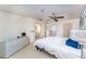 Bedroom featuring white furniture, a ceiling fan, and two closets at 6141 Palmetto Dr, Indian Lake Estates, FL 33855
