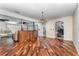 Elegant dining room with wood floors, chandelier and built in cabinetry at 6141 Palmetto Dr, Indian Lake Estates, FL 33855