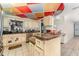 Functional kitchen with tile floor, colorful ceiling, and stainless steel appliances at 6141 Palmetto Dr, Indian Lake Estates, FL 33855