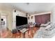 Cozy living room with a large screen television, modern furniture and hardwood floors at 6141 Palmetto Dr, Indian Lake Estates, FL 33855