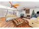 Cozy living room with fireplace, ceiling fans, wood floors and comfortable seating at 6141 Palmetto Dr, Indian Lake Estates, FL 33855