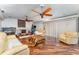 Spacious living room with fireplace, ceiling fans, wood floors and comfortable seating at 6141 Palmetto Dr, Indian Lake Estates, FL 33855
