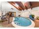 Indoor pool area featuring a vaulted wood ceiling and skylights, a tranquil retreat for relaxation and exercise at 6141 Palmetto Dr, Indian Lake Estates, FL 33855