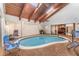 Indoor pool area featuring a vaulted wood ceiling and skylights, a tranquil retreat for relaxation and exercise at 6141 Palmetto Dr, Indian Lake Estates, FL 33855
