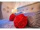 Main bedroom with rose pillows and patterned bedding at 3231 Cupid Pl Pl, Kissimmee, FL 34747