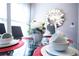 Glass dining table with red placemats, white dishes, and centerpiece at 3231 Cupid Pl Pl, Kissimmee, FL 34747