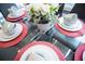 Table setting with white dishes and red placemats at 3231 Cupid Pl Pl, Kissimmee, FL 34747