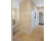 Upstairs hallway with carpet and doors to bedrooms at 3231 Cupid Pl Pl, Kissimmee, FL 34747